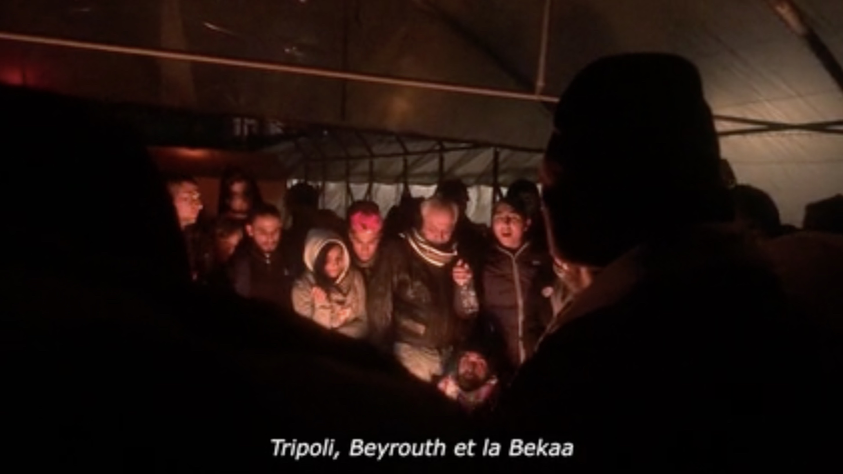 film still, a crowd of people in low light