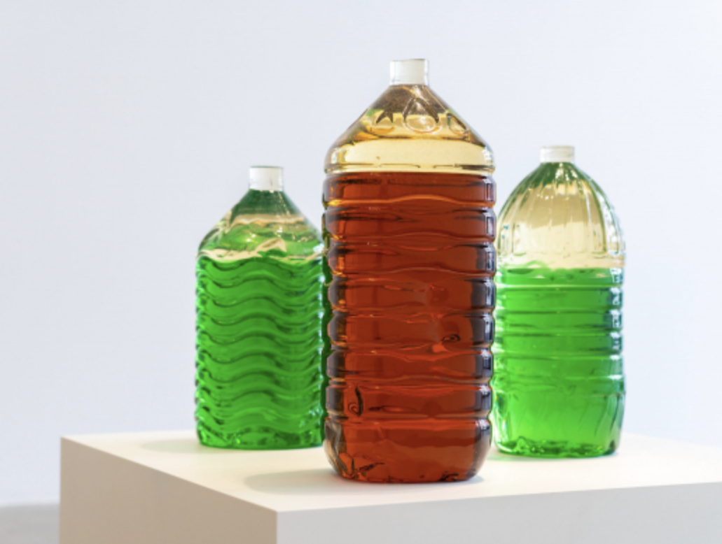 3 large water bottles made of resin with green or red interior