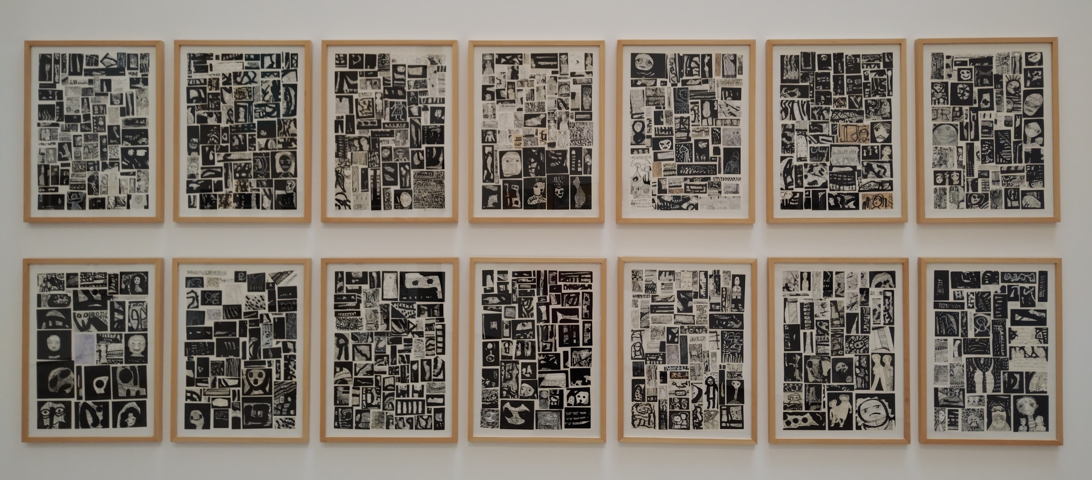two rows of seven framed ink collages