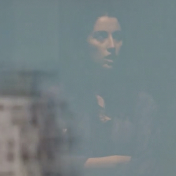 film still with a woman speaking